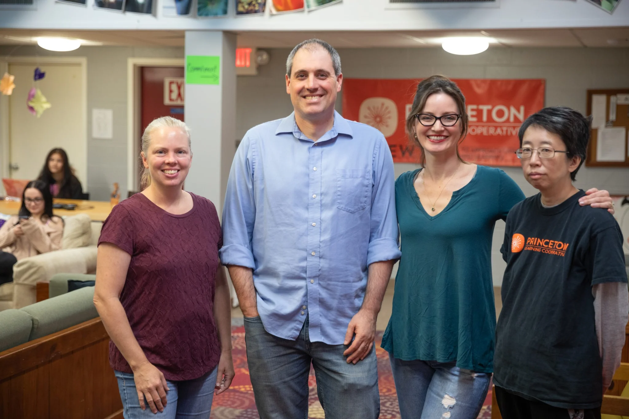 Four staff members posing for group picture in PLC space
